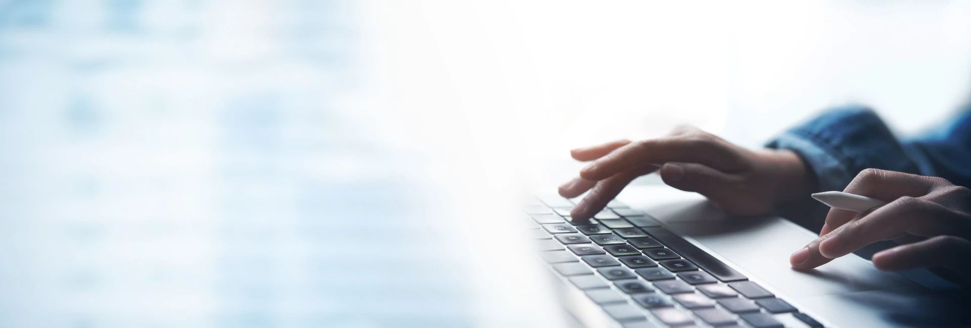 Hands typing on a keyboard 