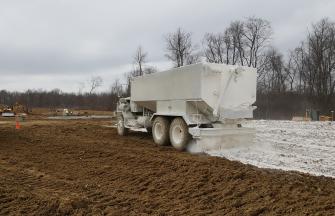 Lime spreading on wet soil to stabilize