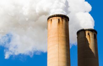 Two smoke stacks with steam coming out