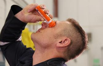 A man who is just applying diphoterine to his eyes