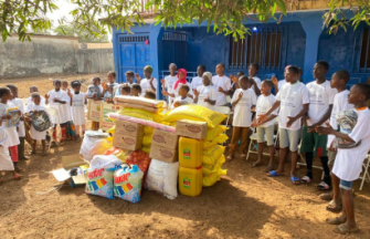 Children behind bags of donated foods