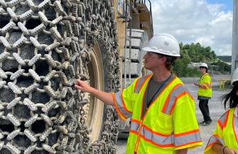 Young man looking at tire