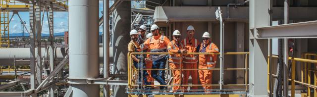 Team in a plant wearing full PPE's