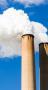 Two smoke stacks with steam coming out